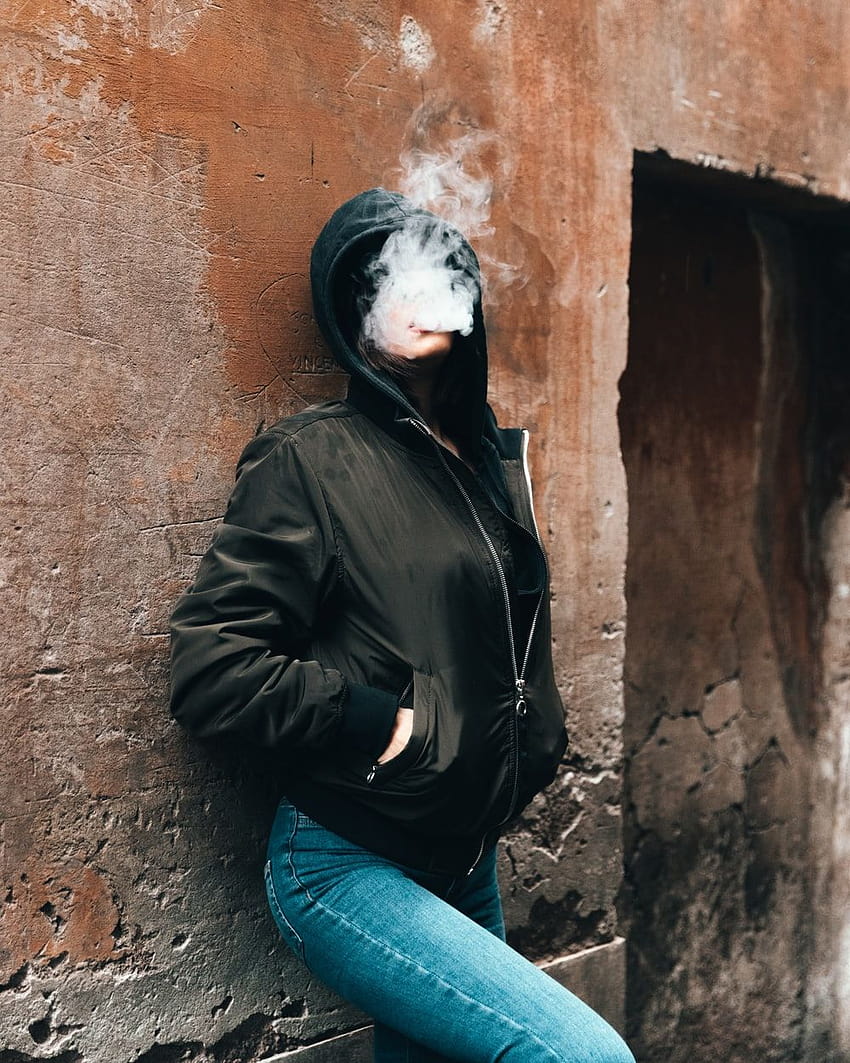 woman smoking while leaning on the wall – Jacket on, women vaping HD phone wallpaper