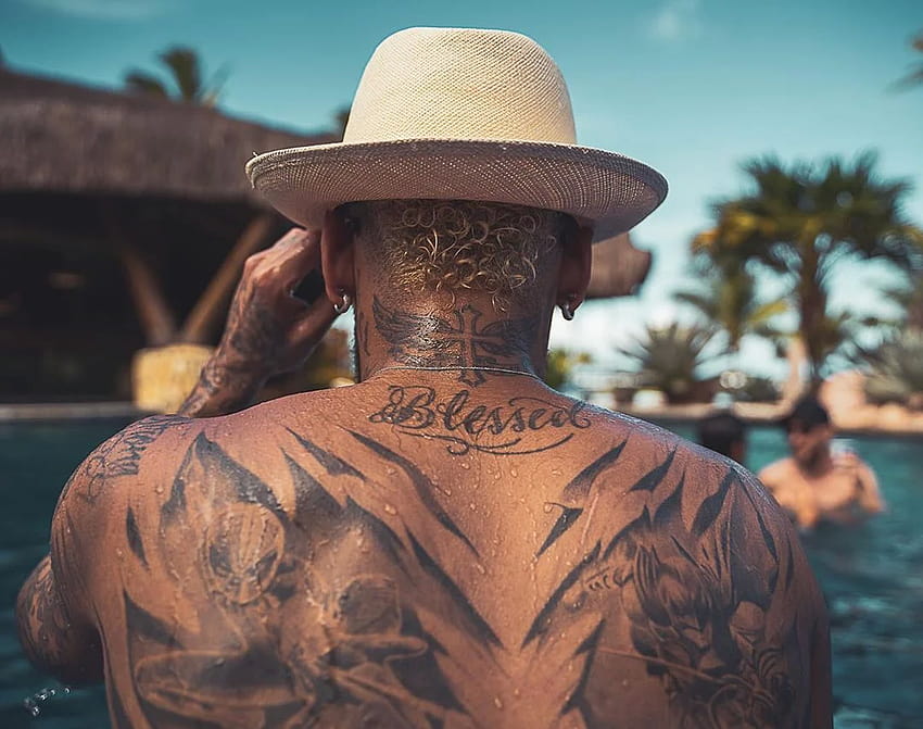 Blessed tattoo on Neymars upper back and winged