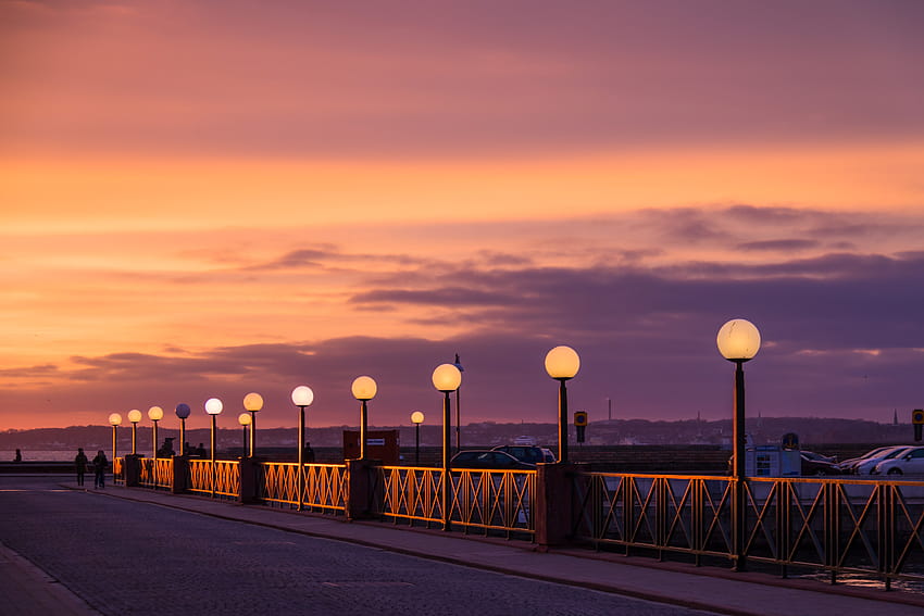 View of lighted lampposts and orange twilight sky, morning twilight HD wallpaper