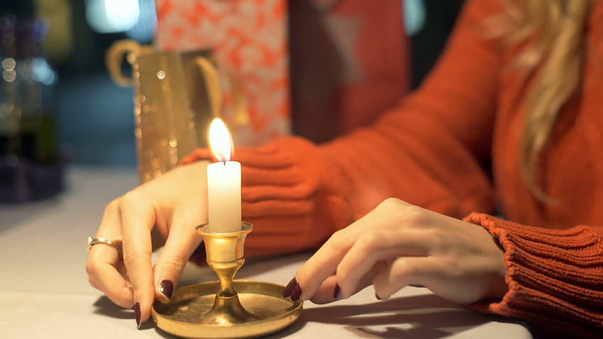 Girl holds burning candle and warms her hands in the cafe, girl and candle HD wallpaper