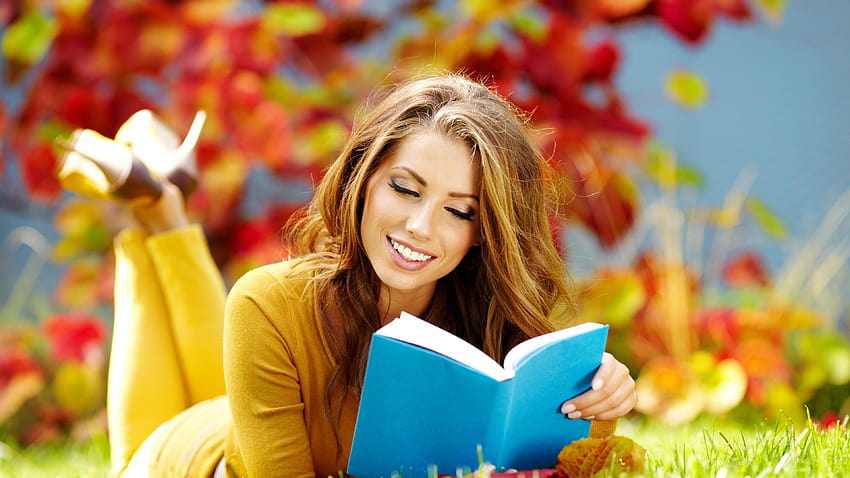 Girl in yellow reading a book on the grass in garden, spring reading HD wallpaper