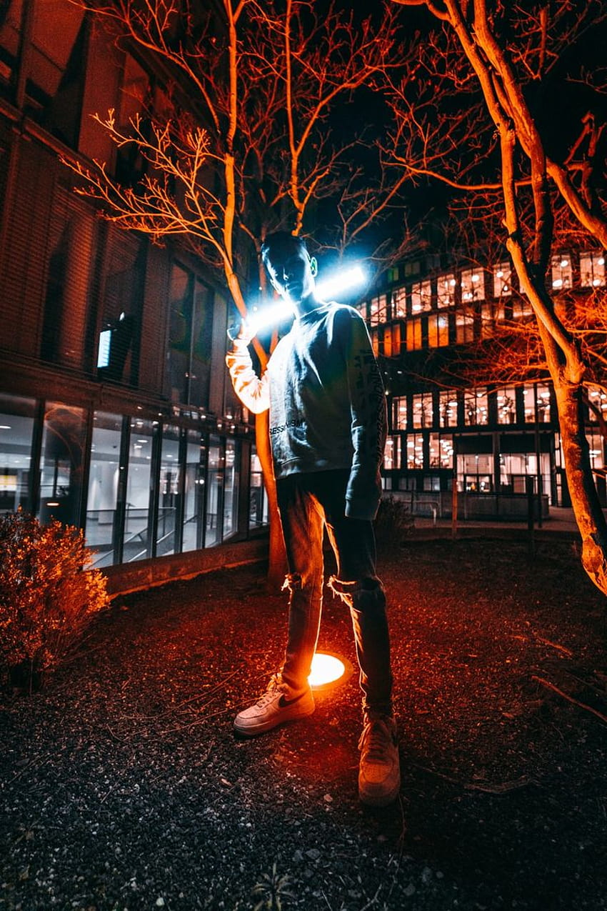 man standing behind of red LED light – Flare HD phone wallpaper