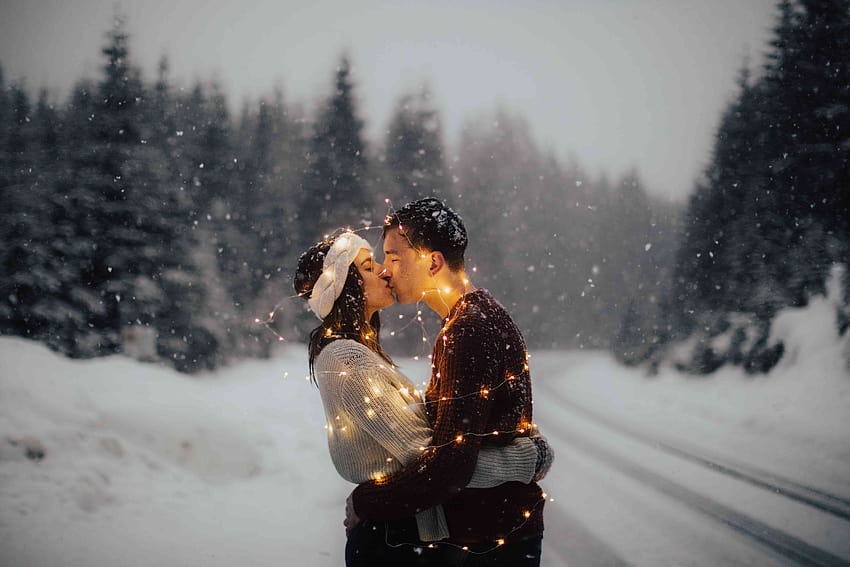 Couple enjoying snowfall hi-res stock photography and images - Alamy