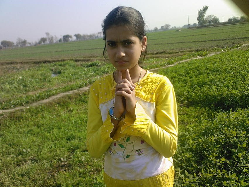 Cute girl playing in grassy field in Village Pindori Kalan HD wallpaper