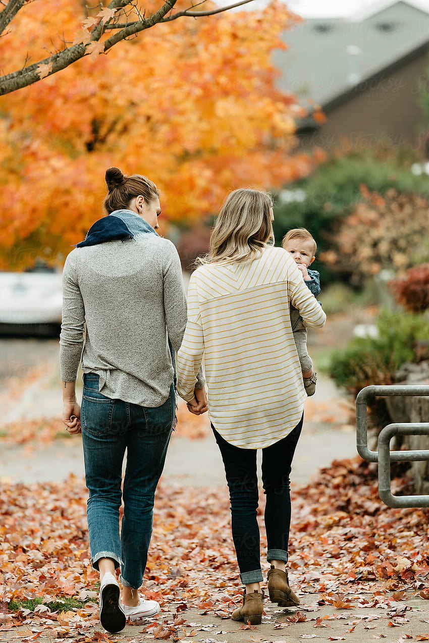 Lesbian Moms Walking With Baby Daughter On Sidewalk In The Fall. by ...