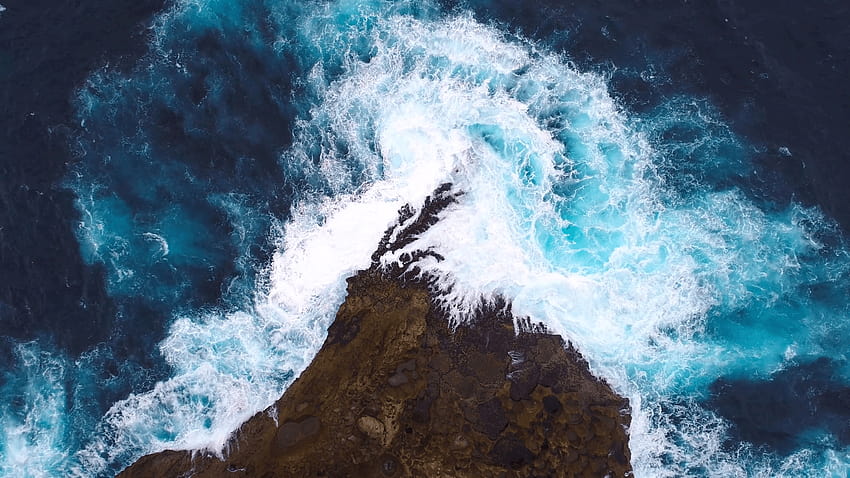Aerial view by drone camera. Ocean with waves and rocky cliff. Cliff with waves crashing against a rocky shore, Nusa Penida, Indonesia. zoom in, rocky shore drone view HD wallpaper