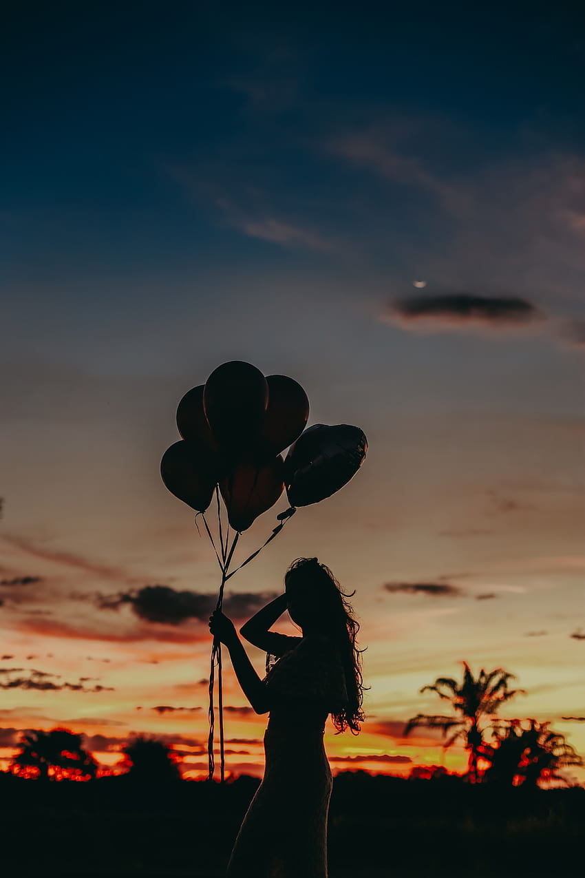 Silhouette of Woman Holding Balloons during Sunset · Stock, women carrying balloons HD phone wallpaper