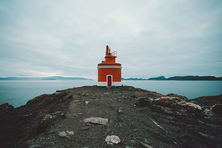 Red and White Lighthouse on Cliff · Stock, rocky cliff lighthouse HD wallpaper