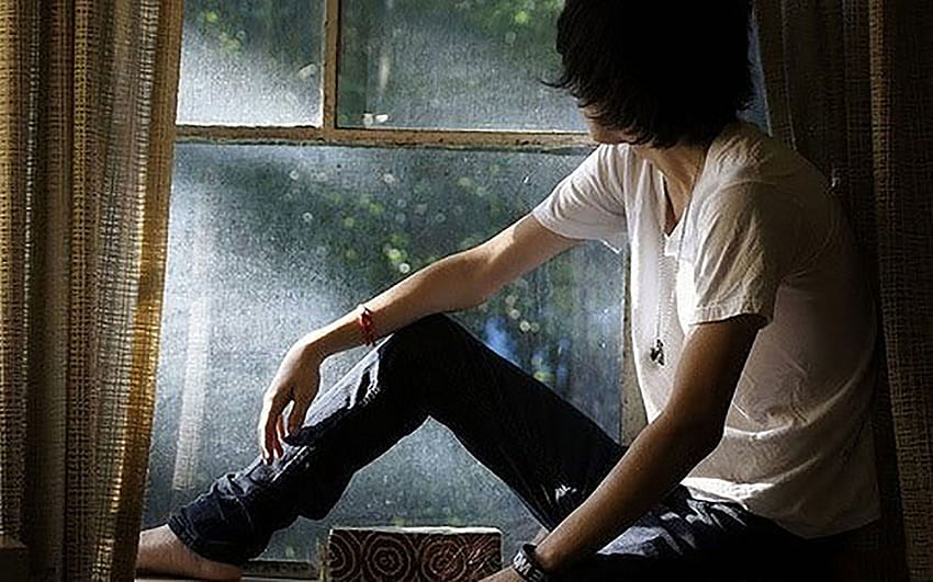 Sad boy sitting near window Stock Photo by ©belchonock 115156044