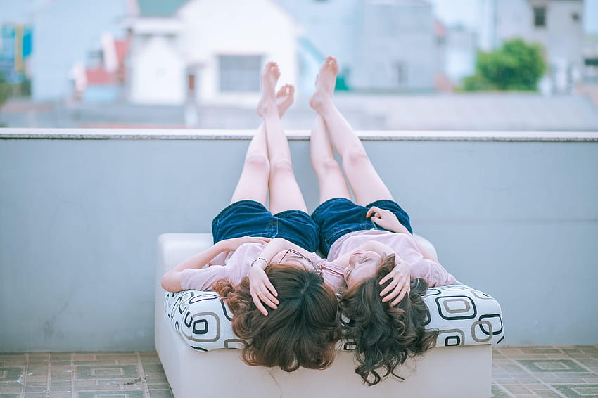 Two woman lying on white and black mattress, lesbian love HD wallpaper