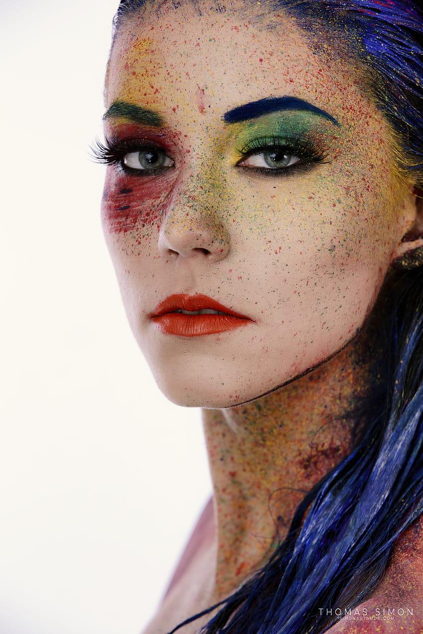 : Thomas Simon, women, blue hair, looking at viewer, body paint, face paint, colorful, makeup, lipstick, splatter, portrait, glamour, simple background, white background, eyeliner, red, green, yellow 1365x2048, women paint face HD phone wallpaper