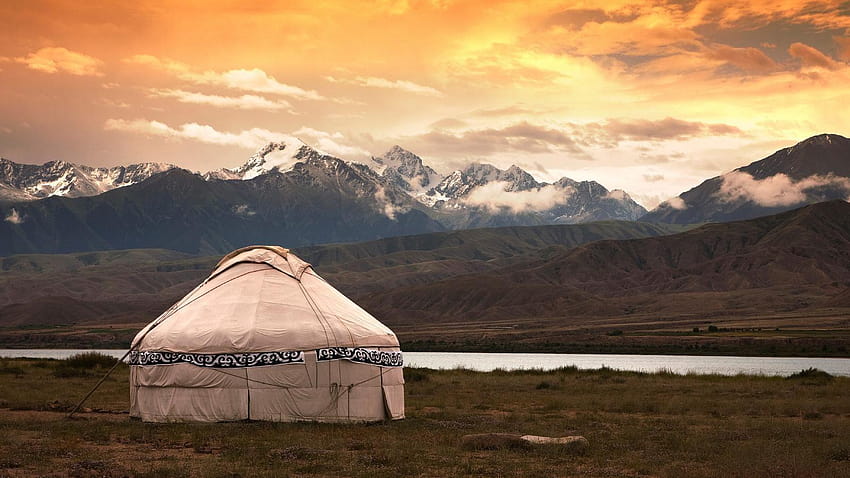 Mongolian yurt among a grassy and rocky landscape in Mongolia HD wallpaper