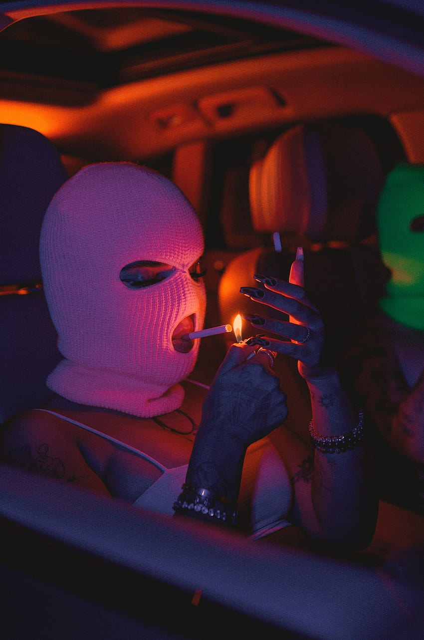 Woman in mask lighting cigarette while sitting in car · Stock HD phone wallpaper