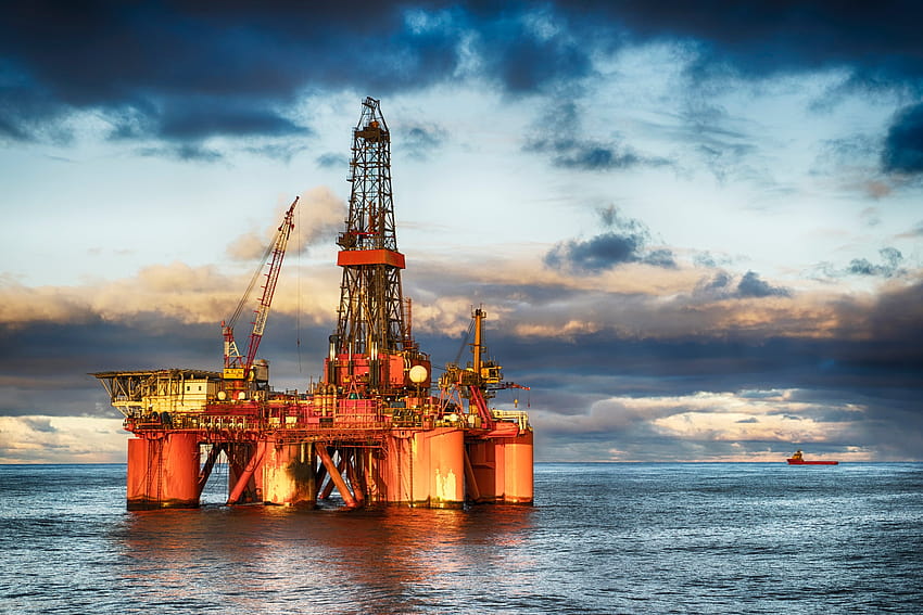 An Offshore Drilling Rig In The Ocean At Dusk HD wallpaper