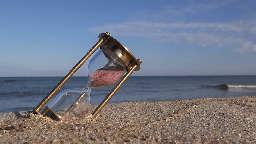 ancient brass sandglass hourglass on sea beach sand Stock Video, sand timer HD wallpaper