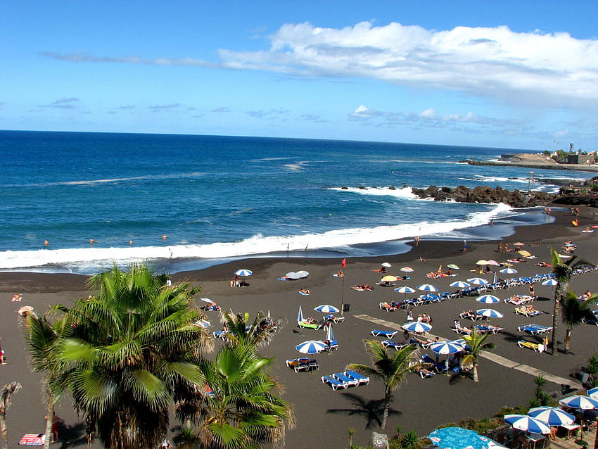 Tourism on the black beach in Tenerife and HD wallpaper
