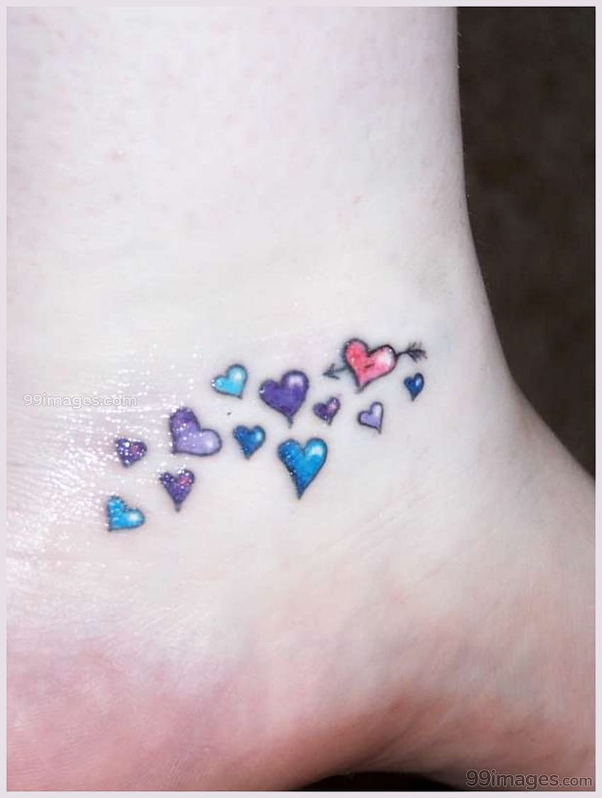 Minimalist UV ink heart tattoo on the wrist