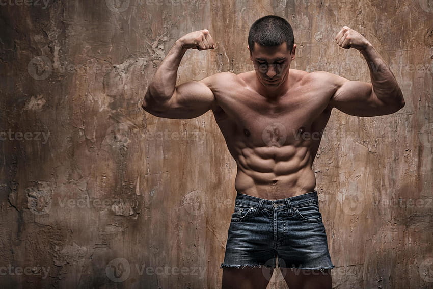 Muscular man on wall background. Strong man 783161 Stock at Vecteezy HD wallpaper