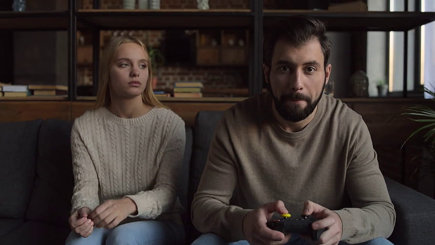 Boyfriend and girlfriend playing video games with controller on console  Stock Photo by ©DragosCondreaW 564191710