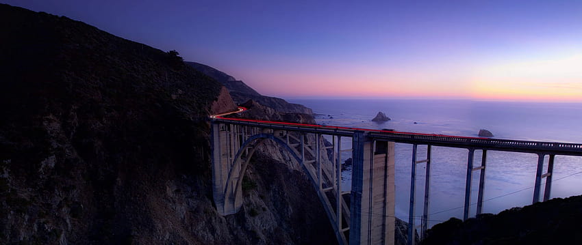 2560x1080 bridge, sea, cliff, lights, night, sea cliff bridge HD wallpaper