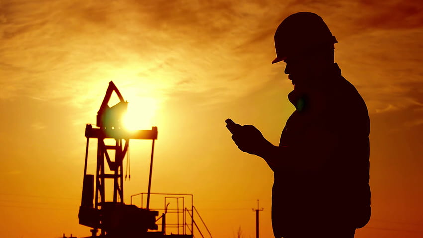 Silhouette Of Oilfield Worker At Crude Oil Pump In HD wallpaper