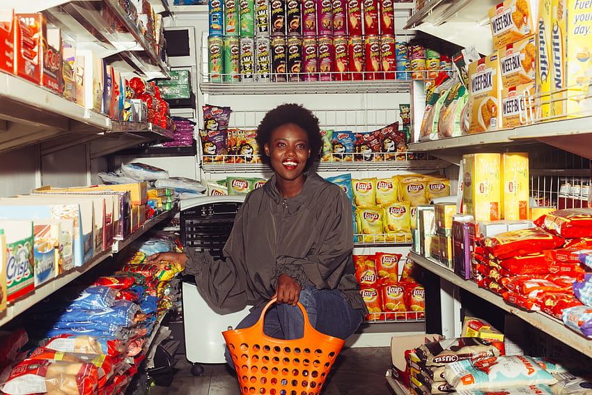 Smiling black woman choosing goods in grocery store · Stock, women grocery HD wallpaper