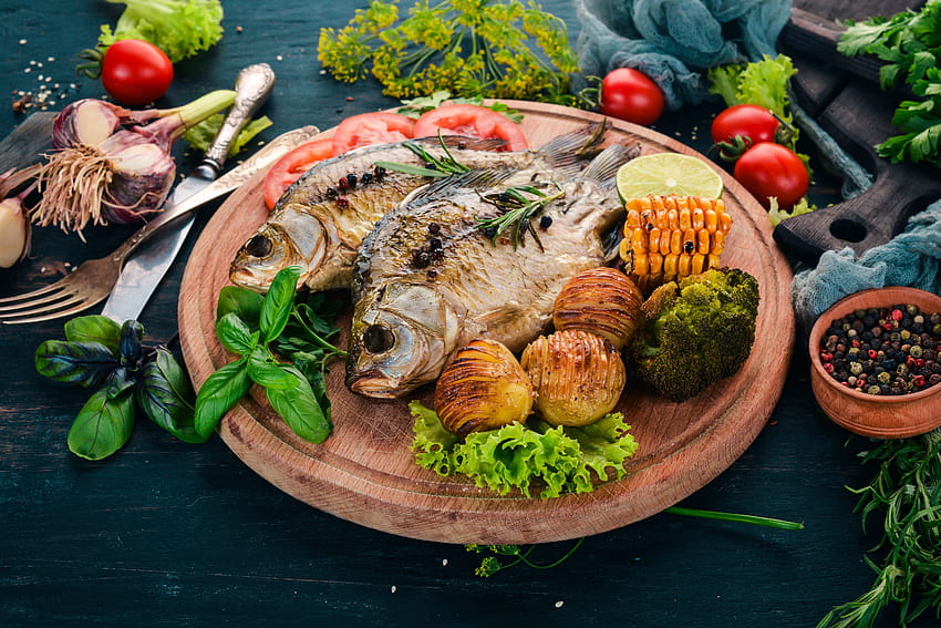 Grilled fish on a board with vegetables and HD wallpaper