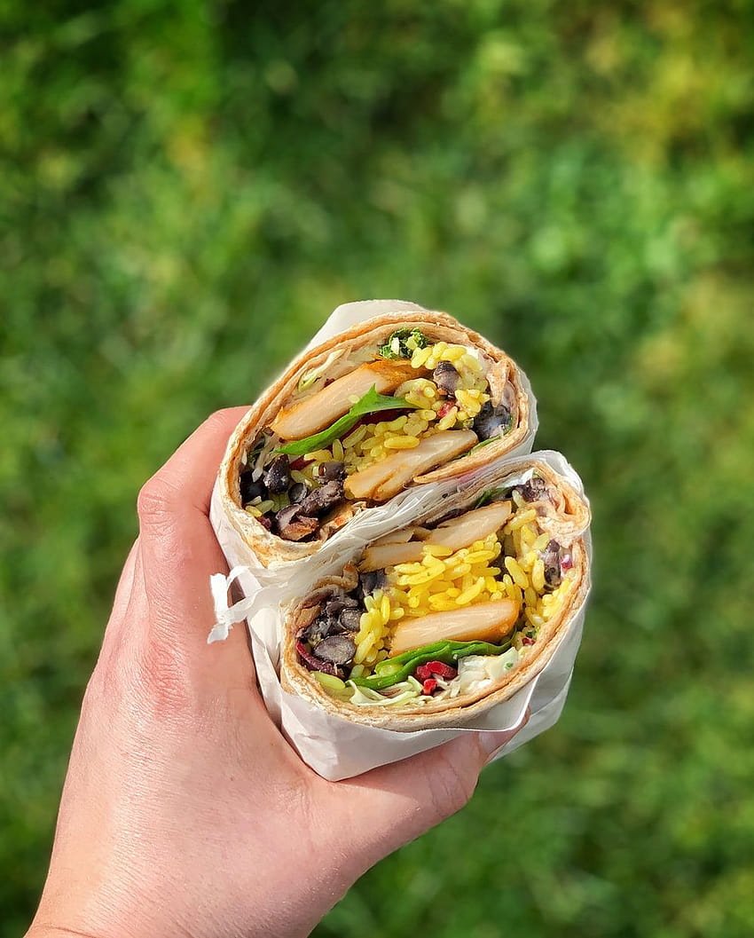 Premium Photo | A foilwrapped burrito on a wooden table wallpaper