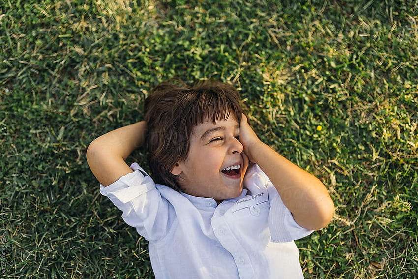 Cute Laughing Kid Lying On Grass by VICTOR TORRES, laughing boy HD wallpaper