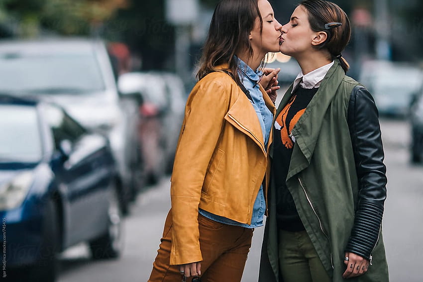 two colorfully dressed girls in love kissing on the street, gay kiss HD wallpaper