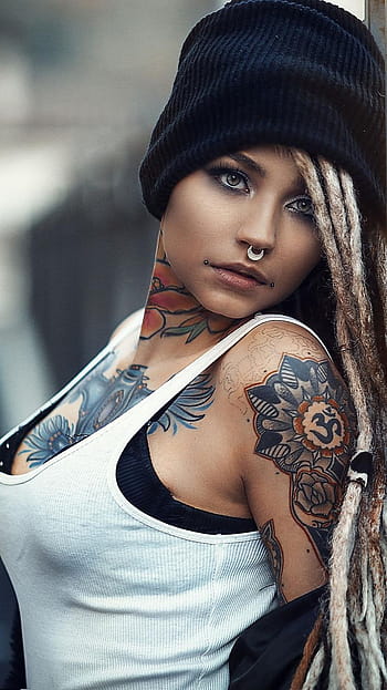 The mans hand in tattoos and jewelry embraces a girls waist. Stock Photo by  ©simbiothy 250326982