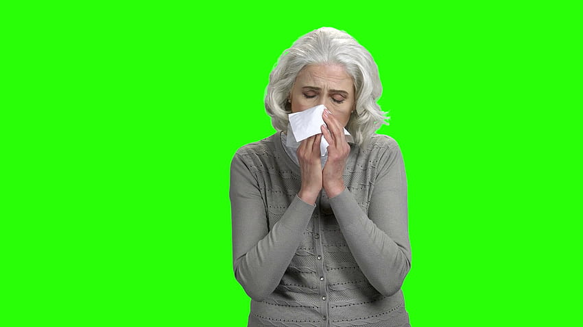 녹색 화면에 재채기 백인 여자입니다. 아픈 노인 여성이 종이 티슈에 재채기를 합니다. 키잉을 위한 크로마 키 배경. 스톡 비디오 영상 HD 월페이퍼