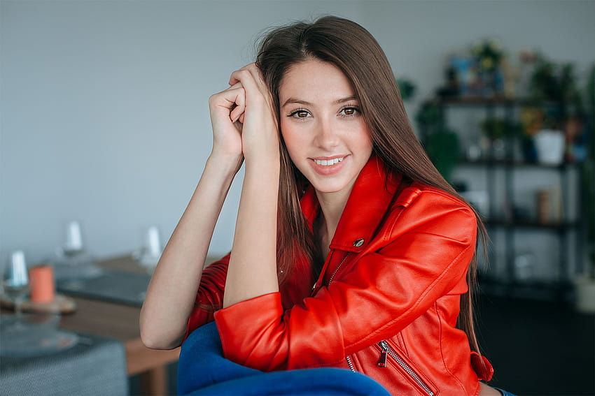 : model, brunette, looking at viewer, smiling, portrait, depth of field, sitting, long hair, face, jacket, leather jackets, red jackets, women indoors 2400x1600, female jacket HD wallpaper