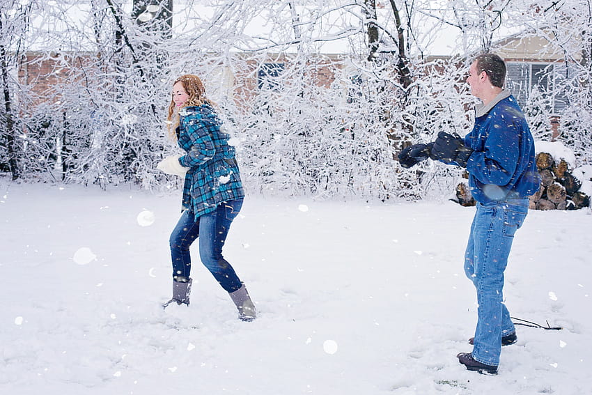 couple with jacket throwing a snowball to each other during daytime, snowball fights HD wallpaper