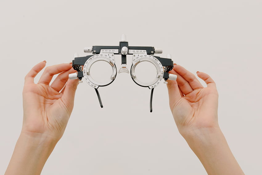 Gesichtslose Optikerin führt Brillen vor · Stock HD-Hintergrundbild