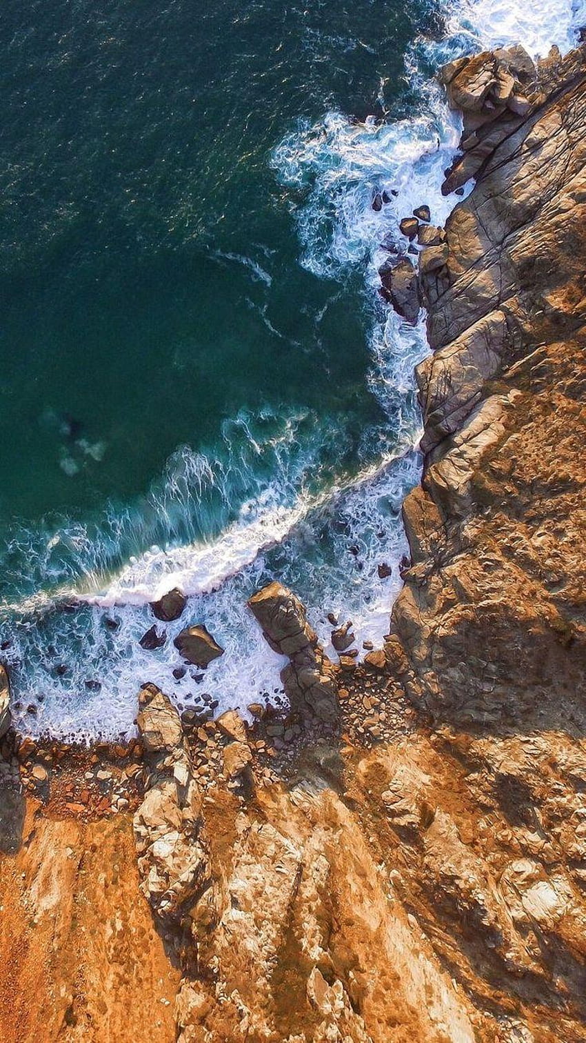 A ragged cliff line + an aerial view of the crashing waves, rocky shore drone view HD phone wallpaper
