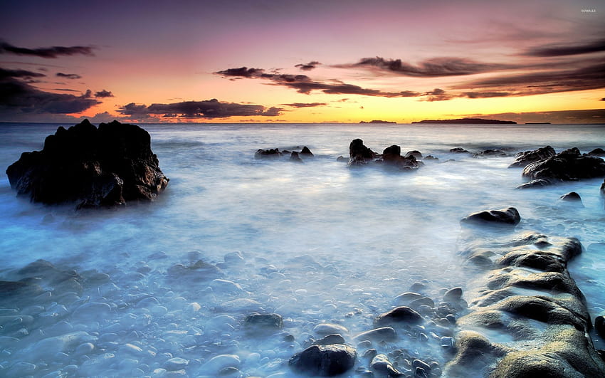 Rocks rising towards the sunset from the mysterious ocean, oceanic rock HD wallpaper