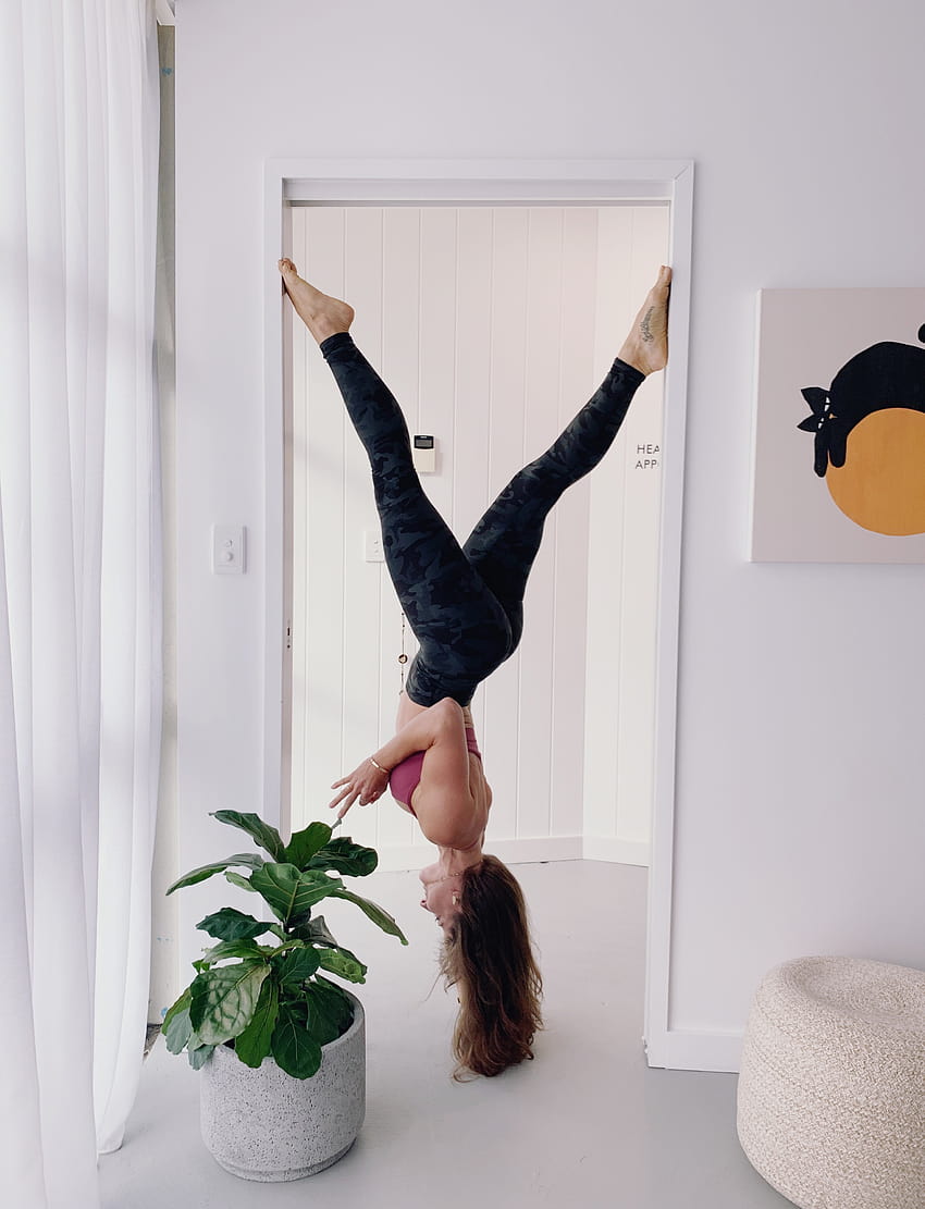 Woman in Workout Gear Hanging Upside Down on Doorway Near Green Plants · Stock, female acrobat HD phone wallpaper