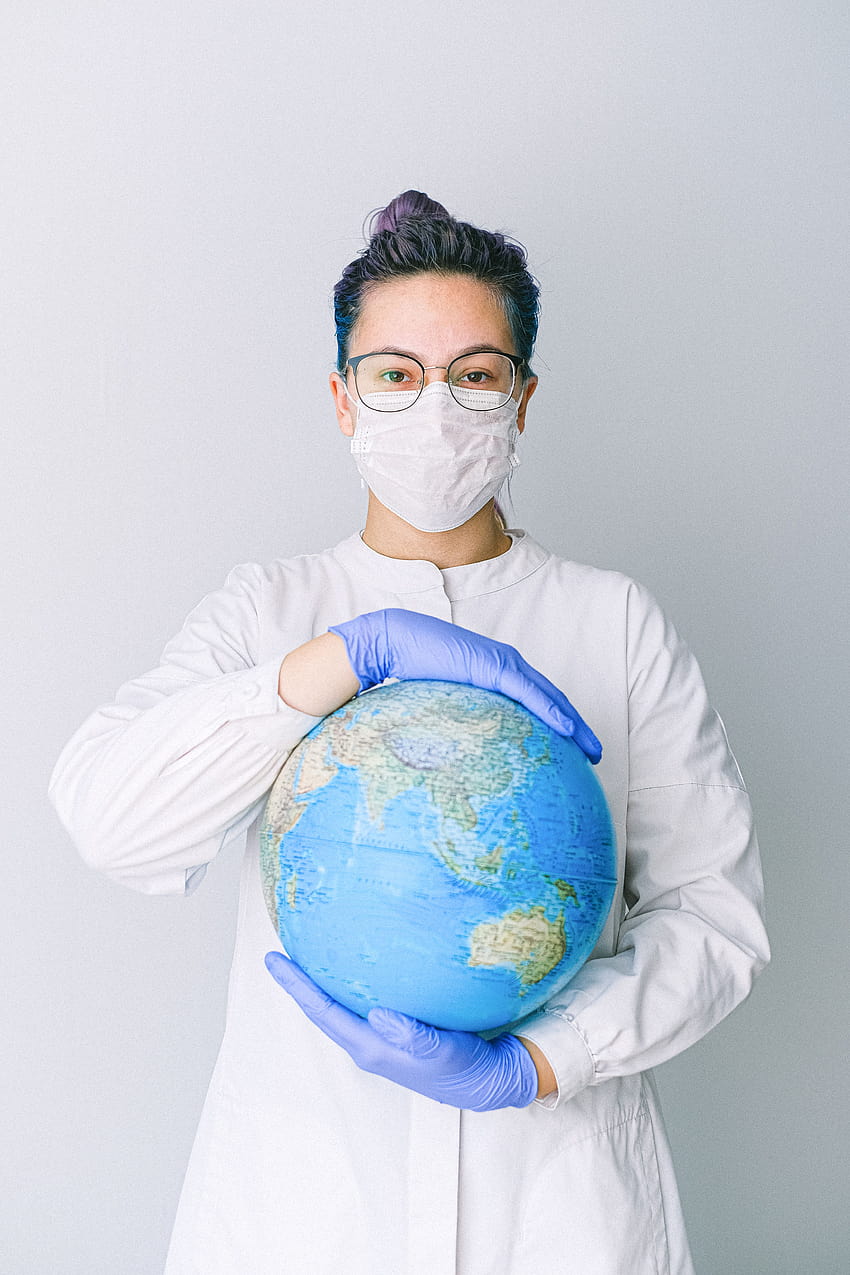 Person With a Face Mask and Latex Gloves Holding a Globe · Stock, earth with a mask HD phone wallpaper