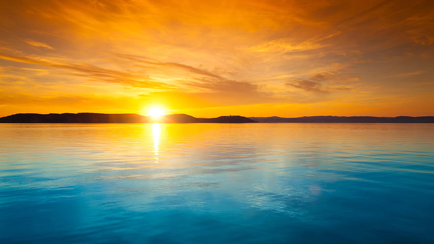 Orange sky over the blue water at sunset and HD wallpaper