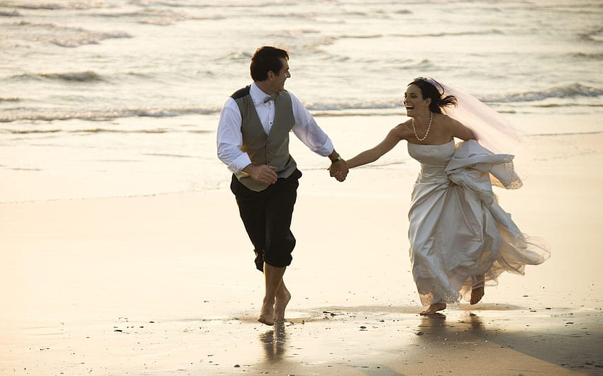 Bride and Groom Running on the Beach HD wallpaper