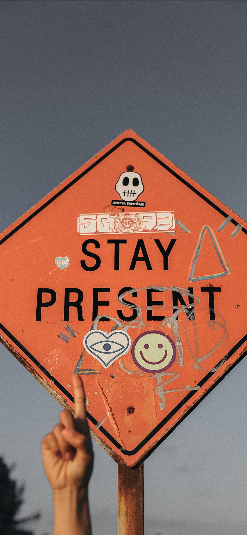 person pointing Stay Present road sign during dayt... iPhone 11, street sign HD phone wallpaper